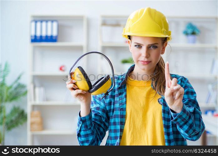 Woman in workshop with noise cancelling headphones