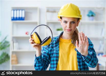 Woman in workshop with noise cancelling headphones. The woman in workshop with noise cancelling headphones