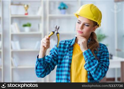 Woman in workshop with pliers. The woman in workshop with pliers