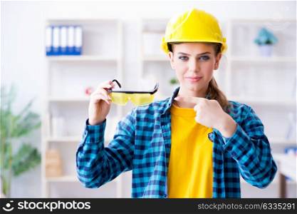 Woman in workshop with protective goggles