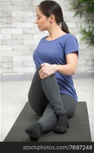 woman in yoga half spinal twist position