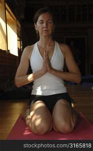 Woman in yoga position meditating