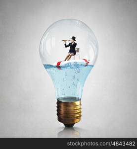 Woman inside light bulb. Young businesswoman floating on life buoy inside of light bulb