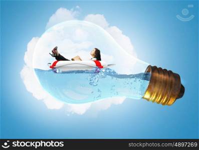 Woman inside light bulb. Young businesswoman floating on life buoy inside of light bulb