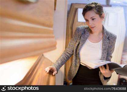 woman inspecting wood for coffin