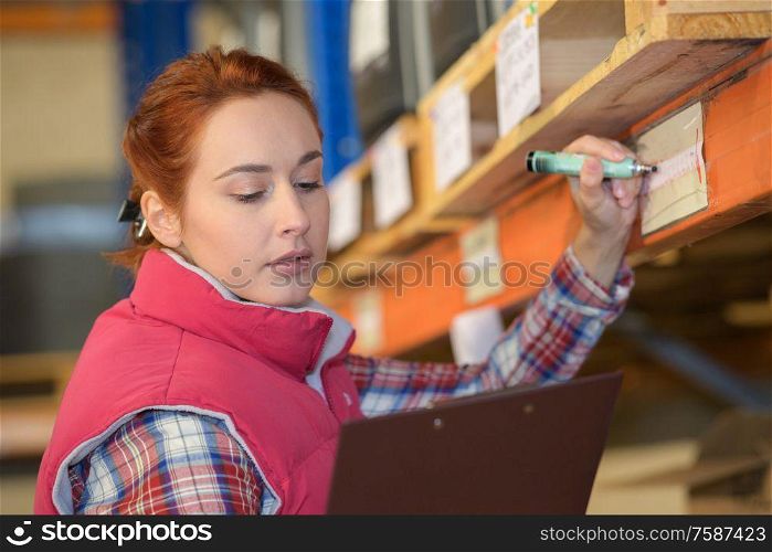 woman inspector doing inventory in a warehouse