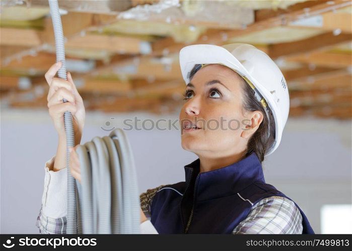 woman installing cable in renovation property