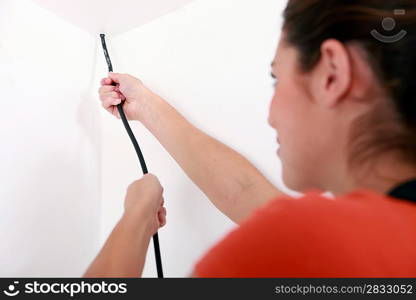 Woman installing wiring