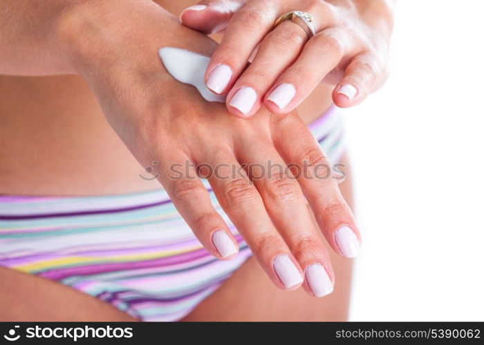 Woman is applaying moisturizing cream for hand care