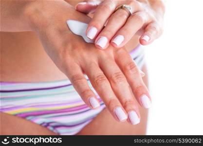 Woman is applaying moisturizing cream for hand care