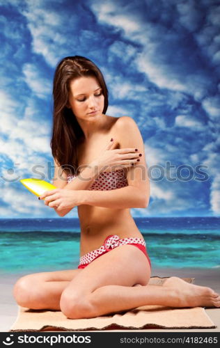 woman is applying sun block cream at beach, dramatic skies