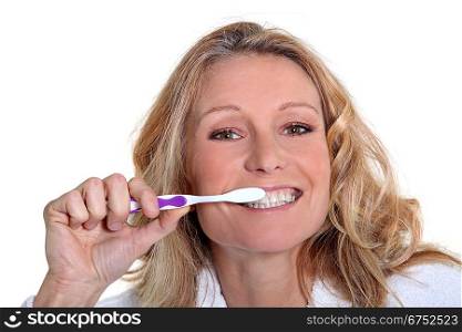 Woman is brushing her teeth