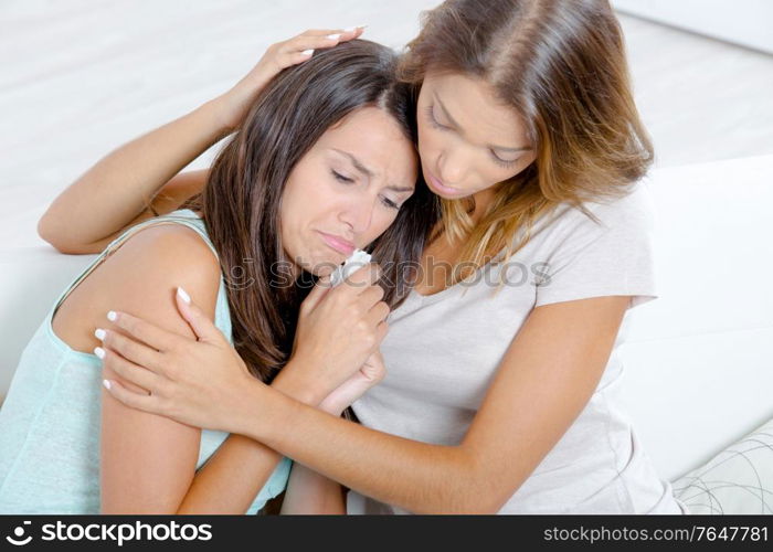 woman is comforting her crying friend