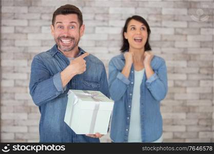 woman is delighted with gift from her husband