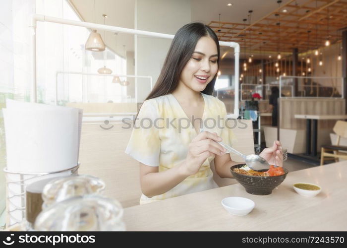 Woman is eating in Restaurant with social distancing protocol while lockdown City due to Coronavirus pandemic