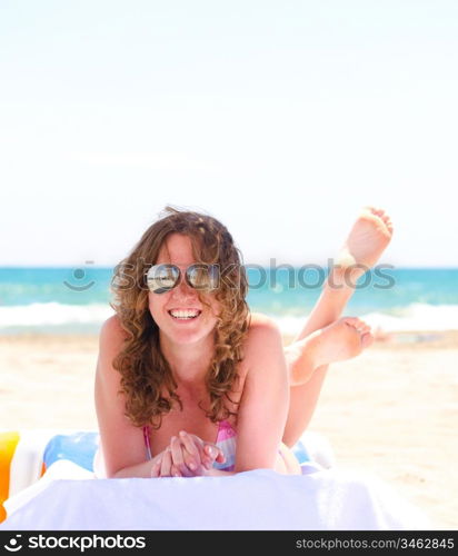 woman is lying at tropical beach near sea