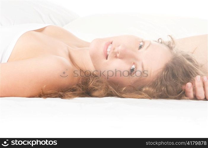 woman is lying in bed at sunny morning