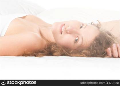 woman is lying in bed at sunny morning