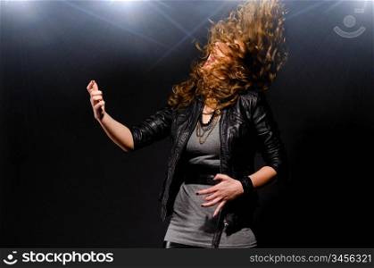 woman is playing rock music on air guitar
