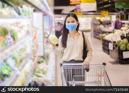 woman is shopping in supermarket with face mask
