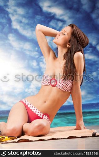 woman is sitting at beach, dramatic skies