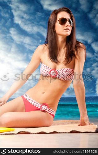woman is sitting at beach in sunglasses, dramatic skies