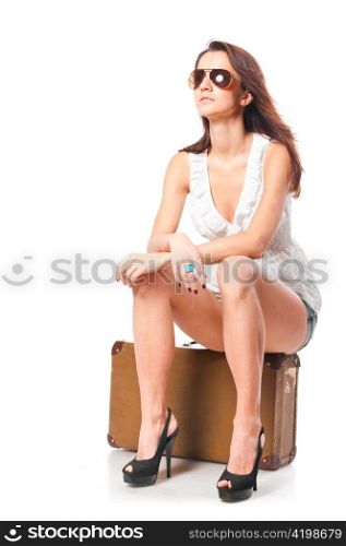 woman is sitting on old leather case