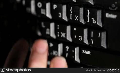 Woman is typing on the keyboard. Surfing the internet. Warm light. Closeup.