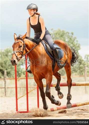 Woman jockey training riding horse. Sport.. Woman jockey training riding horse jumping over fence. Equestrian sport competition.