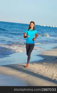 Woman jogging at evening beach