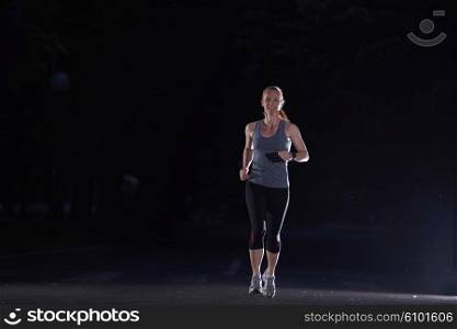 woman jogging in night dark, early morning running training