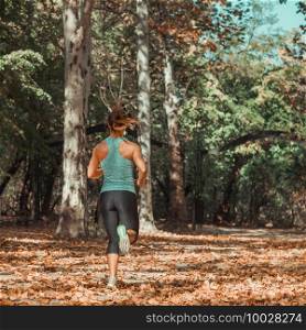 Woman Jogging in Public Park in The Fall  