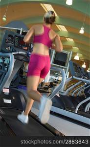 Woman Jogging on Treadmill at Gym