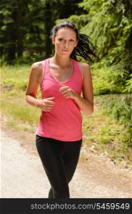 Woman jogging outdoor running on sunny day countryside path