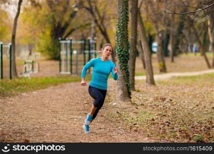 Woman Jogging Outdoors in Park. Nature, park, yellow background . Jogging Outdoors. Attractive Woman, Park, Nature