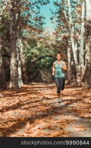 Woman Jogging Outdoors in The Fall, in Public Park