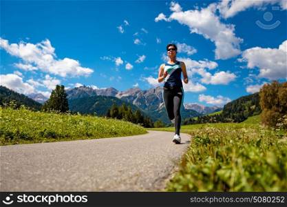 Woman jogging outdoors. Italy Dolomites Alps