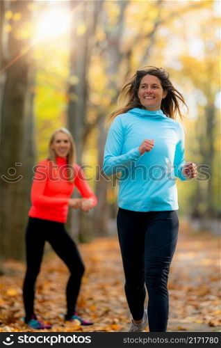 Woman Jogging, Personal Fitness Trainer Looking at a Smart Watch During Training in the Park. . Trainer Looking at a Smart Watch During Training in the Park.