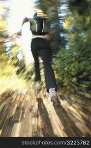 Woman Jogging Through Woods
