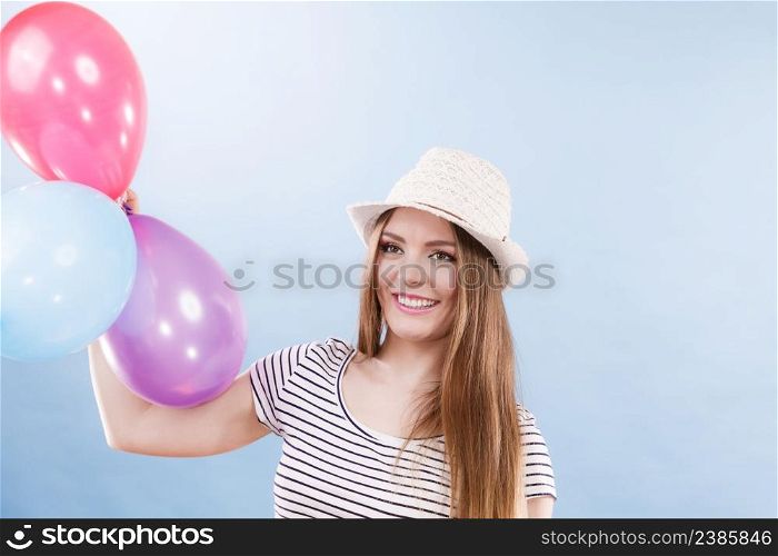 Woman joyful girl playing with colorful balloons. Summer, celebration and lifestyle concept. Studio shot blue background. Woman summer joyful girl with colorful balloons
