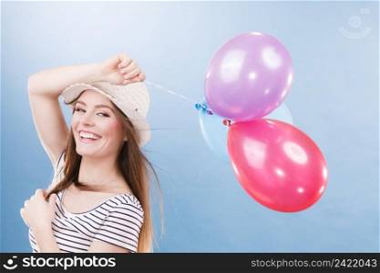 Woman joyful girl playing with colorful balloons. Summer, celebration and lifestyle concept. Studio shot blue background. Woman summer joyful girl with colorful balloons 