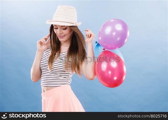 Woman joyful girl playing with colorful balloons. Summer, celebration and lifestyle concept. Studio shot blue background