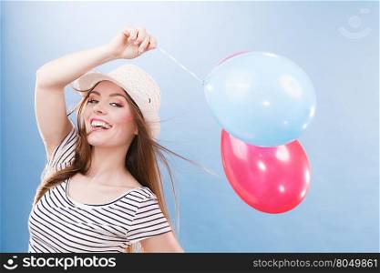 Woman joyful girl playing with colorful balloons. Summer, celebration and lifestyle concept. Studio shot blue background