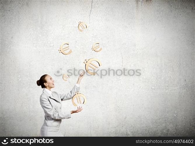Woman juggler. Young pretty businesswoman juggling with euro symbols