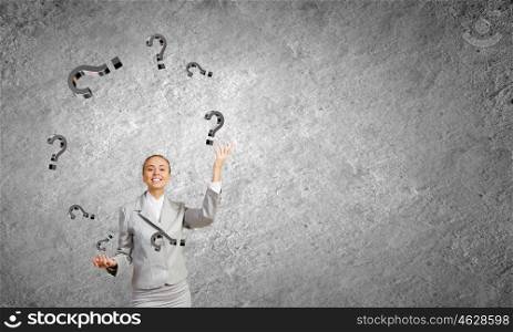 Woman juggler. Young pretty businesswoman juggling with question marks