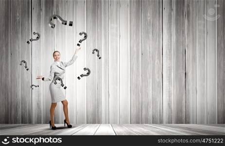 Woman juggler. Young pretty businesswoman juggling with question marks