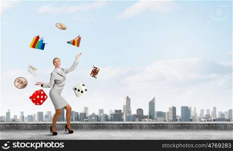 Woman juggler. Young pretty businesswoman juggling with white balls