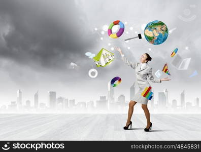 Woman juggler. Young pretty businesswoman juggling with white balls. Elements of this image are furnished by NASA