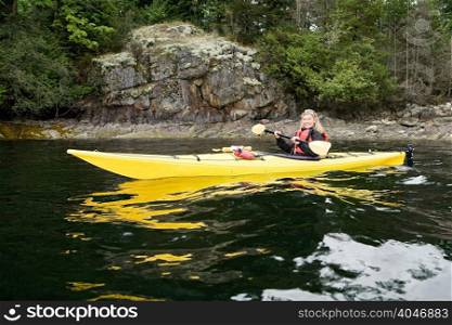 Woman kayaking in fjord