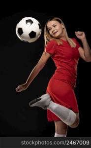 woman kicking ball with foot